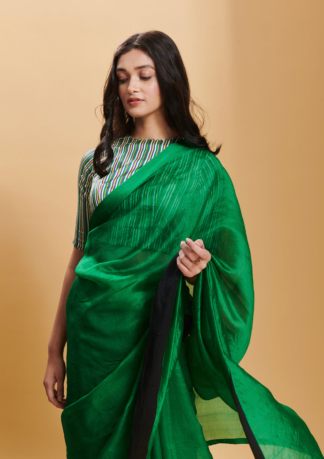 Green handloom saree in handwoven organza mulberry silk, from Surmaye. Dual-colour reversible border in green and black. 