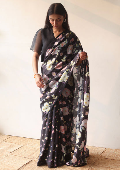 Handloom black saree from Surmaye, with hand-painted floral print on handwoven mulberry silk. Paired with black designer blouse, with scalloped embroidery edges all over. Full view