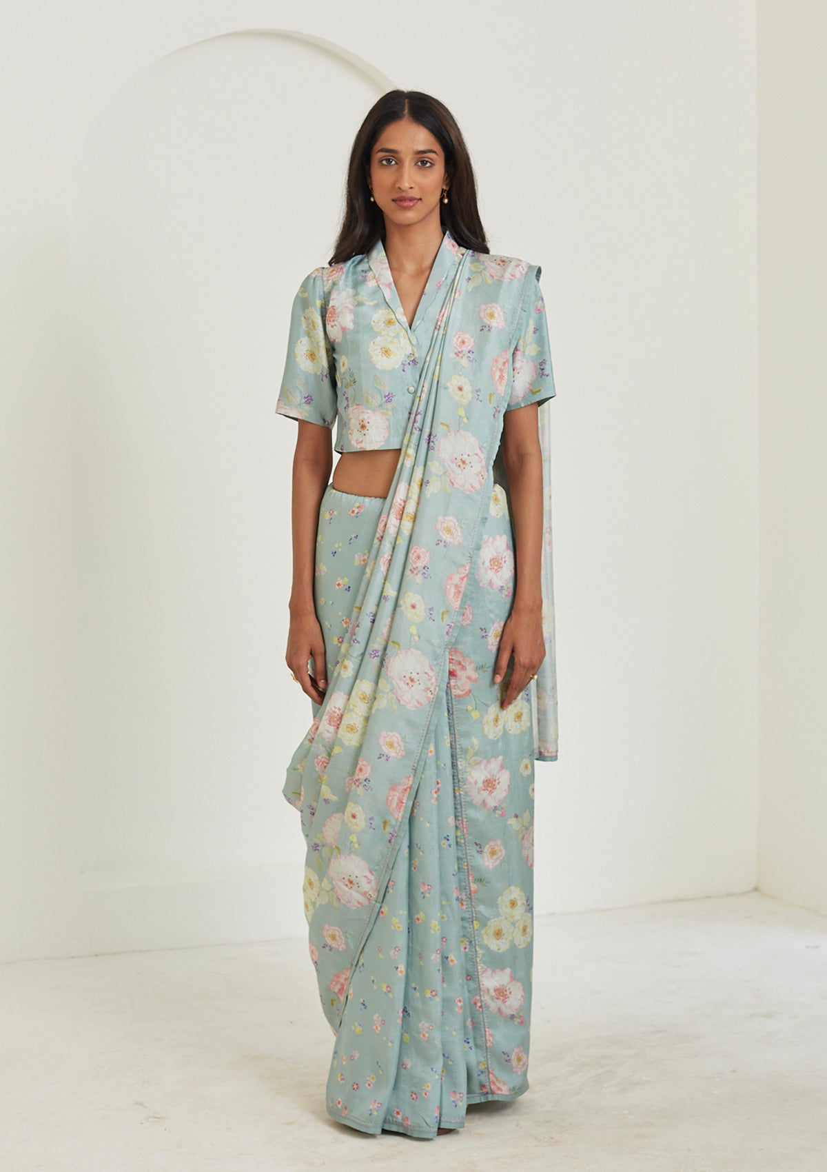 Handloom sage green saree from Surmaye. Hand-painted floral print on handwoven mulberry silk. Paired with sage green designer blouse in floral print. Full view