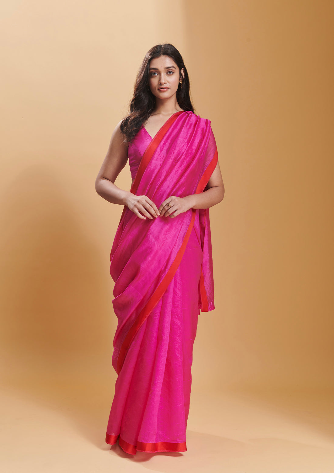 Pink handloom saree in handwoven organza mulberry silk, from Surmaye. Dual-colour reversible border in pink and red.